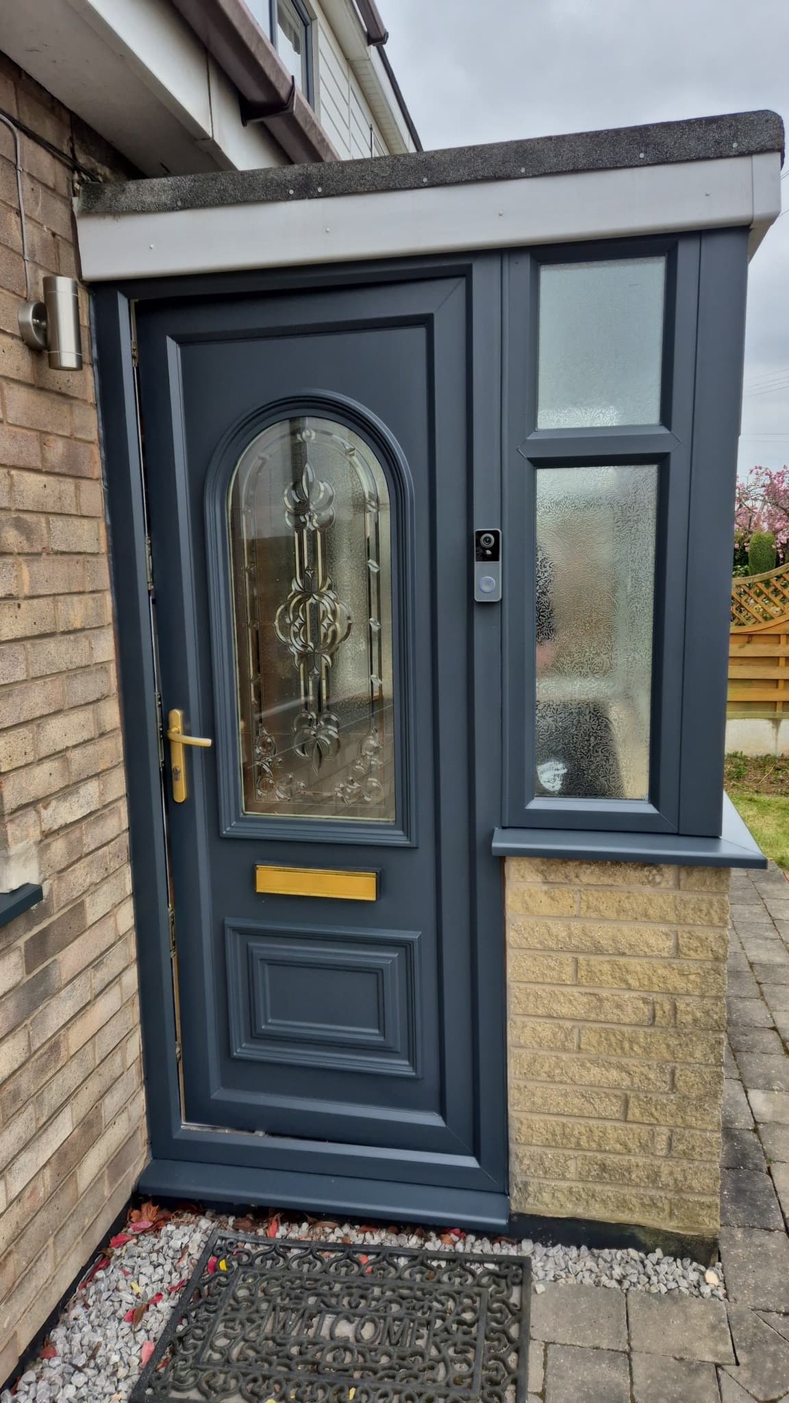 Freshly sprayed anthracite UPVC front door with matching side frame.